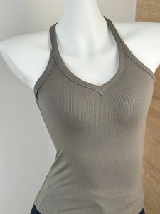 Detail of khaki halter neck V-neck top with elastic ribbed knit texture on mannequin