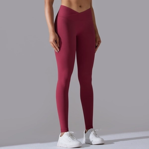 Detail view of dark red high waisted yoga pants with a stylish cross waist design