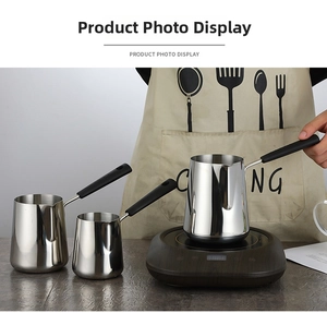 Three sizes of stainless steel saucepans with long handles on a compact electric heater