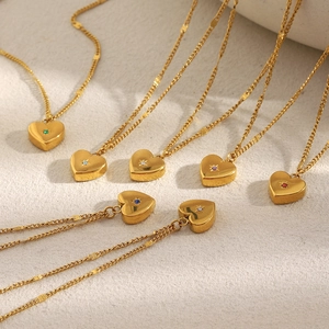 Detailed flat lay of 18K gold-plated heart necklaces with multi-color zircon stones