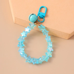 Detailed view of blue star beads, a matching bell, and metallic clip on the keychain
