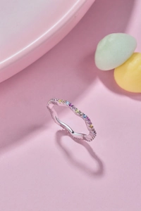 Close-up of wavy S925 sterling silver ring featuring colorful pavé-set cubic zirconia