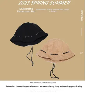Detail view of foldable solid color bucket hat with long braided adjustable drawstring
