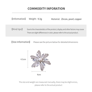 Detailed view of cubic zirconia flower brooch with a white pearl and product dimensions