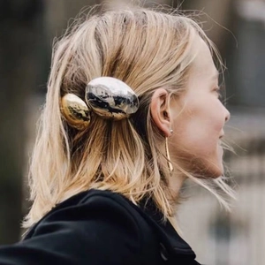 Minimalist metallic egg-shaped hair clip with a polished mirror finish for women