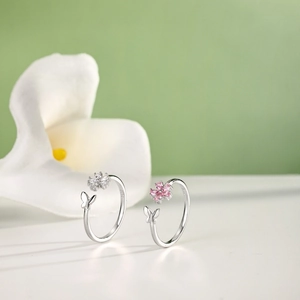 Detail view of S925 sterling silver rings with flower and butterfly zircon stones