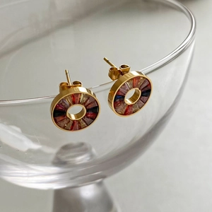 Gold round stainless steel earrings with colorful crystals on a glass rim