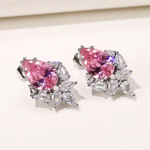 Macro shot of pink pear-cut gemstone earrings with sparkling zircon floral setting