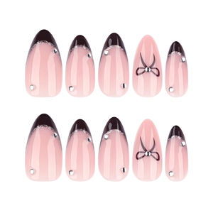 French black tip almond press-on nails with silver glitter and black ribbon bows