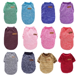 Close-up showing a collection of colorful warm pet sweaters in twelve vibrant soft colors