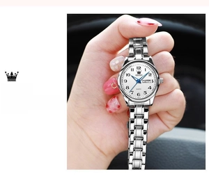 Close-up of OLEVS women's quartz watch with date display and silver stainless steel strap