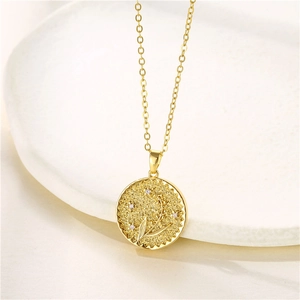 Detail of gold coin necklace with crescent moon, flower relief and zircon inlay