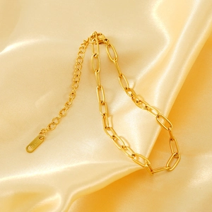 Minimalist 18K gold plated stainless steel paperclip chain anklet on golden silk fabric