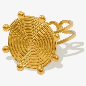 Macro shot of gold spiral ring texture with eight small beads and split band design
