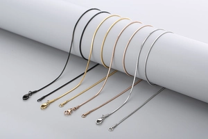 Detail of snake chains in black, gold, rose gold, and silver with lobster clasps