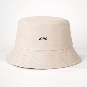 Minimalist beige cotton bucket hat featuring black KING embroidery and stitched brim