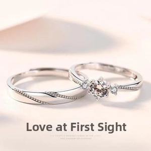 Detailed close-up of silver couple rings set with minimalist textures and a round zircon