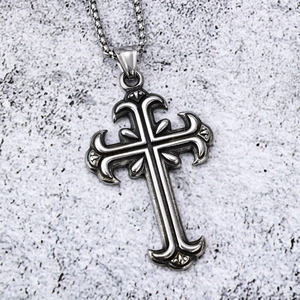 Detailed close-up of retro gothic cross pendant with engraved patterns on round box chain