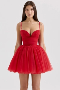 Detail view of the vibrant red mesh layers and corset style bodice on the mini dress