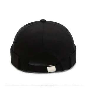Detail of docker hat featuring back metal adjustable buckle and black canvas texture