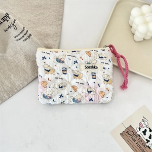 Quilted floral makeup bag with cute puppy print and pink strap in aesthetic setting