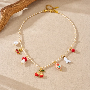Pastel gold charm necklace with cherry, mushroom, and floral ceramic pendants