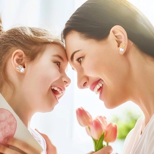 Mother and daughter wearing cute rabbit pearl earrings in a cozy lifestyle setting