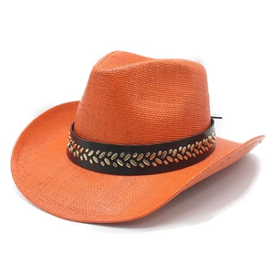 Orange woven straw cowboy hat with black decorative band and golden metal accents