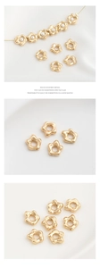Detail of 14K gold plated flower charms and pearls for handmade jewelry making