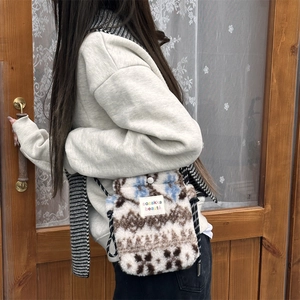 Detailed back view of a plush crossbody bag with geometric floral jacquard pattern