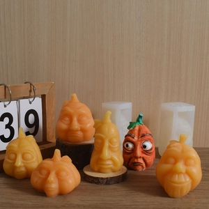 Detail of DIY Halloween pumpkin candle molds showing expressive facial textures and silicone