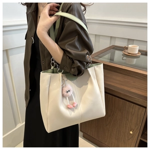 Elegante borsa tote crema con spalline verde menta e ciondolo in peluche rosa