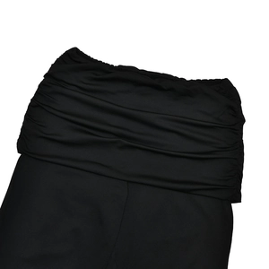 Close-up of black elastic knit fabric showing ruched waist detail and fabric texture