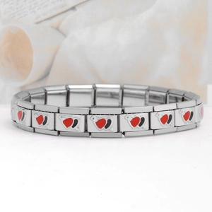 Detailed macro view of Italian modular charm bracelet links with heart enamel art