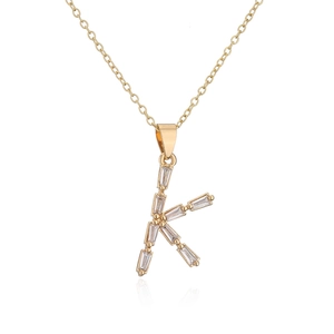 Macro view of 18K gold plated letter K pendant with sparkling zircon gemstones