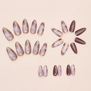 Detail of purple marble cat-eye nails with gold foil and reddish brown press on nails
