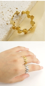 Detail of gold and silver irregular geometric rings with overlapping oval plates
