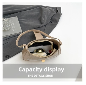 Sparkling gold rhinestone shoulder bag interior showing phone and makeup essentials