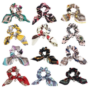 Detailed grid of 12 silk scarf hair scrunchies with pearl charms in various patterns
