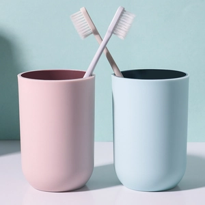 Minimalist plastic mouthwash cup set with pink and blue cups and matching toothbrushes
