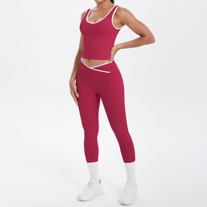 Detail of high-waisted yoga leggings with unique V-shape cross waist and white contrast trim