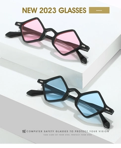 Detail view of avant-garde geometric triangular sunglasses with blue and pink tinted lenses