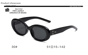 Detail view of vintage oval black frame sunglasses with wide temples and grey lenses