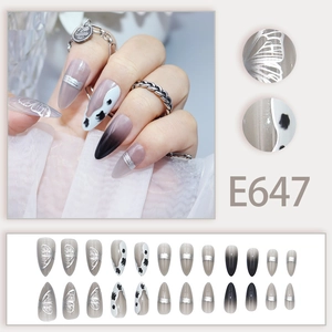 Long almond press-on nails with silver butterflies, cow prints, and grey gradients