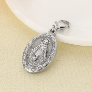 Macro shot of silver Virgin Mary oval pendant with religious text and lobster clasp