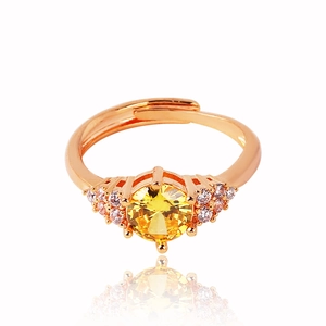 Detailed close-up of adjustable rose gold ring with yellow zircon and pavé stones