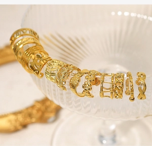 Detail showing assorted 18K gold plated cuff earrings with vintage textured patterns