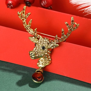 Close-up of vintage reindeer brooch with sparkling rhinestones and a red teardrop gem