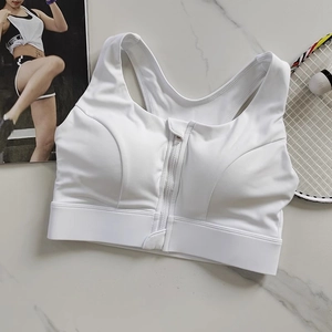 Detail of white front-zip sports bra with fixed cups on marble background