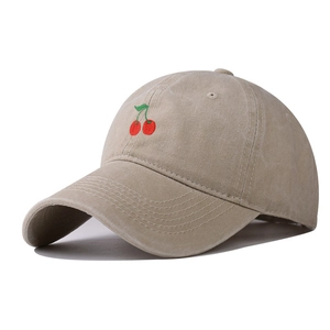 Detail of cherry embroidery on khaki washed cotton vintage baseball cap with neat stitching
